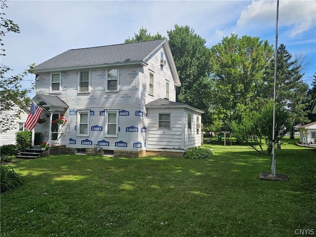 rear view of house with a yard