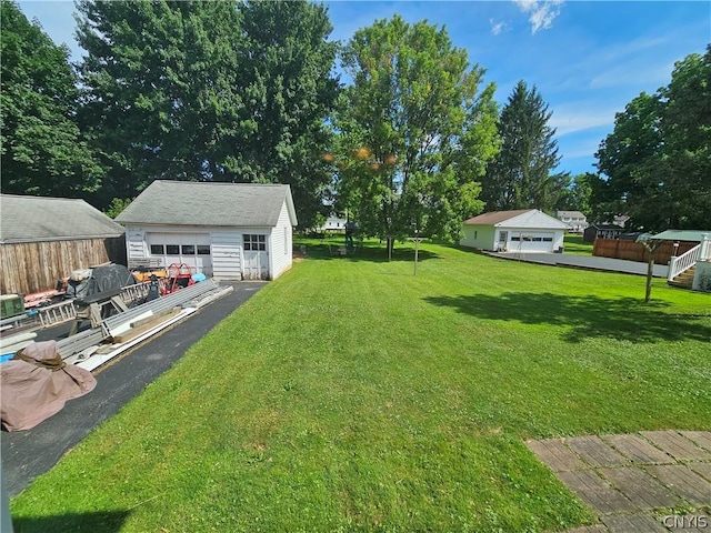 view of yard featuring an outbuilding and a garage