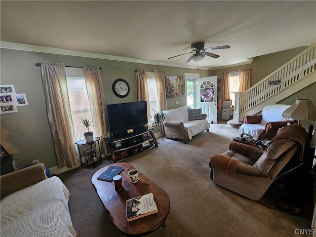 living room featuring ceiling fan, carpet, ornamental molding, and a healthy amount of sunlight