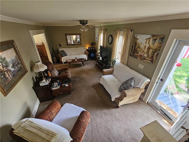 carpeted living room featuring ceiling fan and crown molding