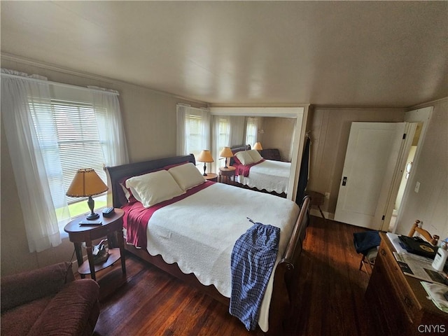 bedroom with dark hardwood / wood-style flooring and crown molding