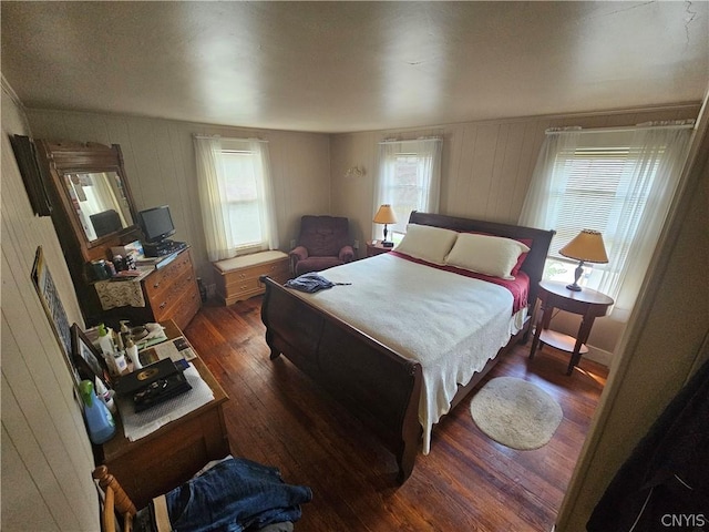 bedroom featuring dark hardwood / wood-style floors and multiple windows