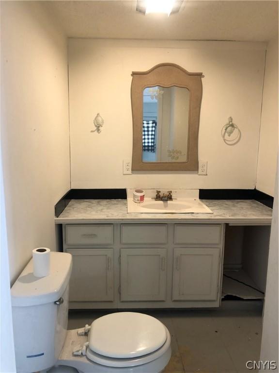 bathroom featuring toilet, tile patterned floors, and vanity