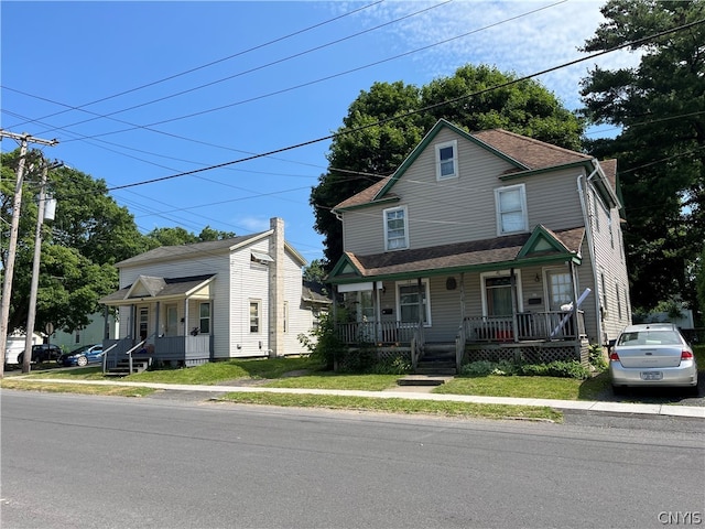 view of front of home featuring covered porch and a front yard