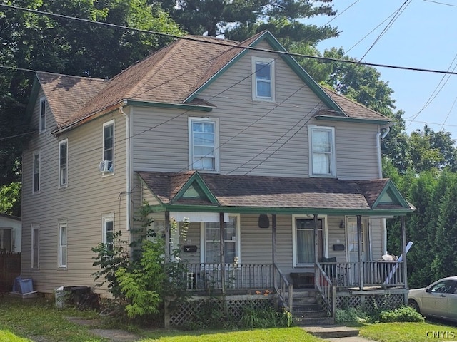 view of front of property with a porch and cooling unit