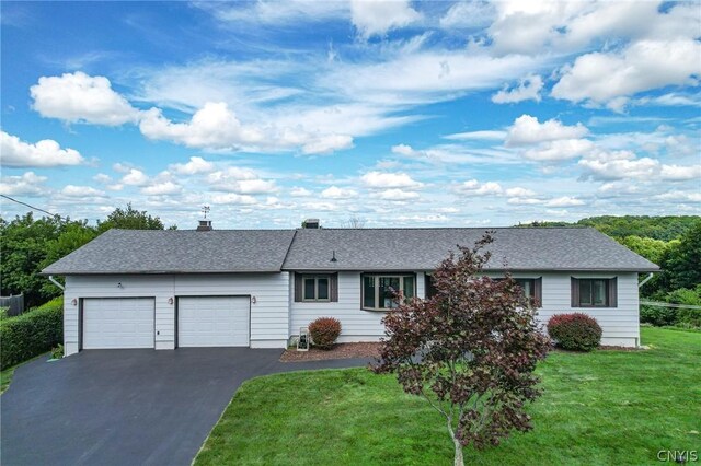 ranch-style house with a garage and a front yard