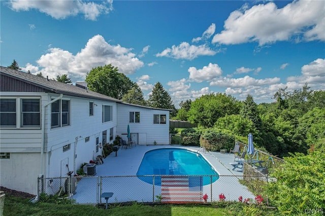 view of swimming pool featuring central air condition unit and a patio area