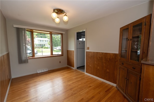 interior space with white fridge and light hardwood / wood-style flooring