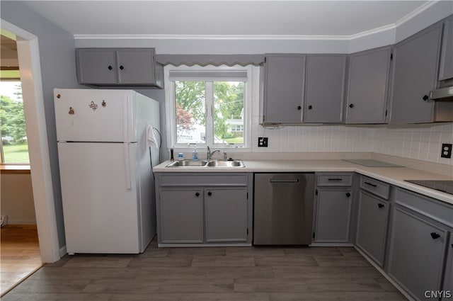 kitchen with dishwasher, white refrigerator, a wealth of natural light, and sink