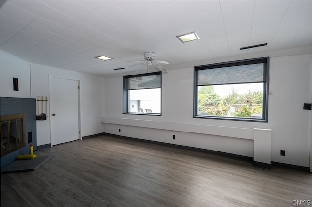 unfurnished living room with hardwood / wood-style flooring, a fireplace, and ceiling fan