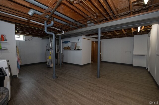 basement featuring water heater and dark hardwood / wood-style flooring