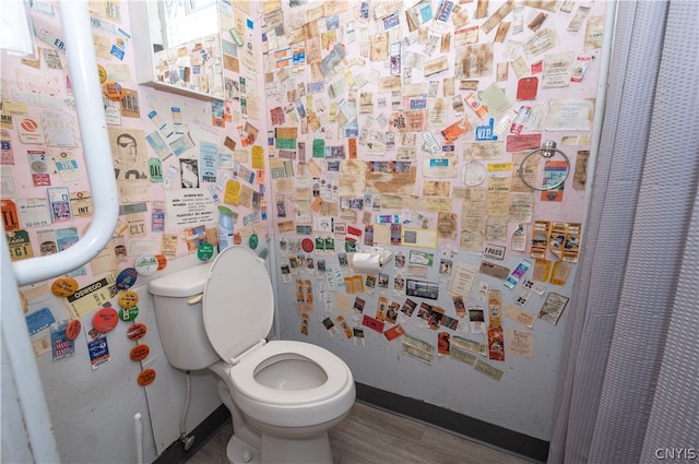 bathroom with hardwood / wood-style floors and toilet