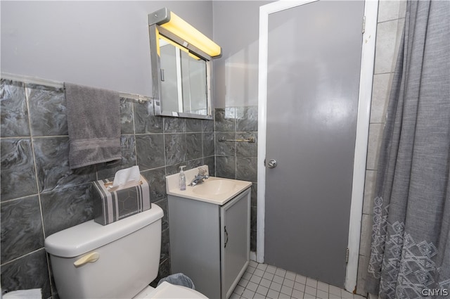 bathroom featuring tile walls, tile patterned floors, toilet, and vanity