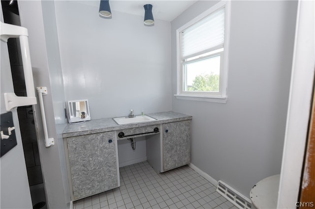 bathroom with vanity, toilet, and tile patterned floors