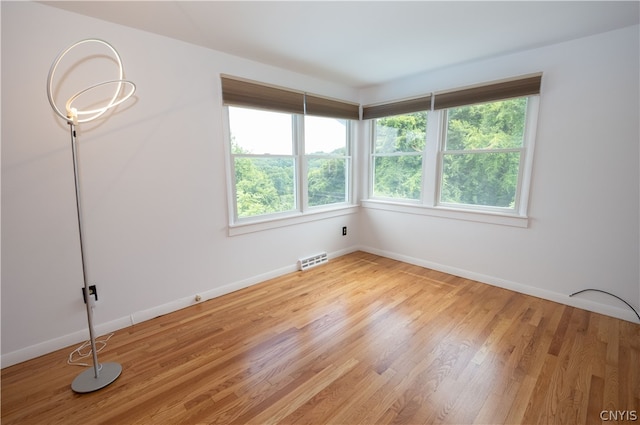 spare room with light wood-type flooring