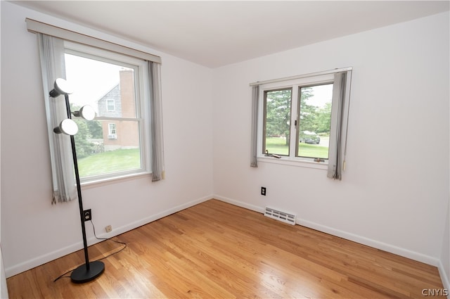 unfurnished room with light wood-type flooring