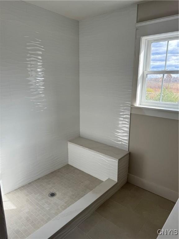 bathroom featuring tile patterned flooring and a shower