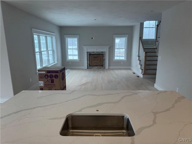 kitchen featuring light stone countertops and a wealth of natural light