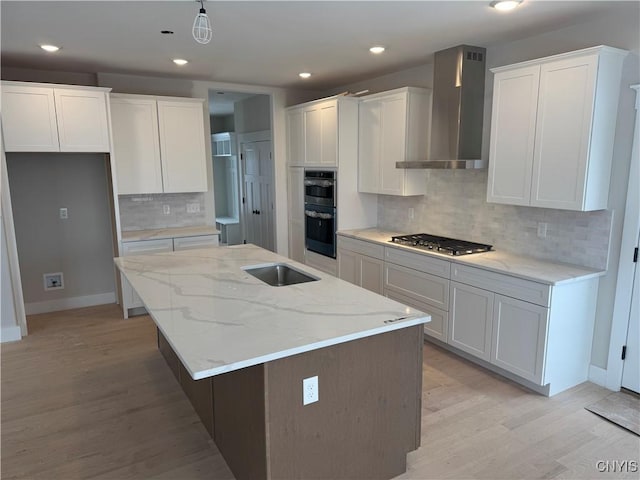 kitchen with white cabinets and wall chimney range hood