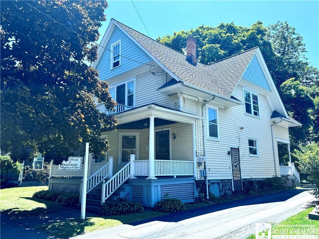 32 White St, Pomfret, NY 14063 - view of front of home featuring a chimney, a porch, roof with shingles, and a balcony