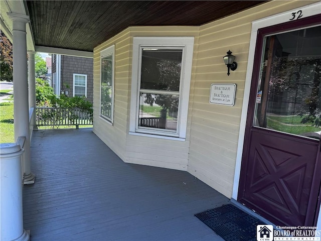 view of exterior entry with covered porch