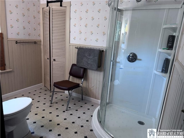 bathroom featuring toilet, tile patterned floors, and walk in shower