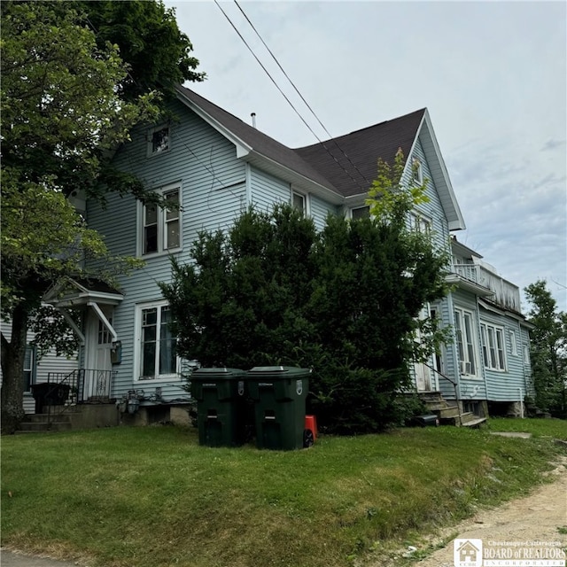 view of side of property with a yard