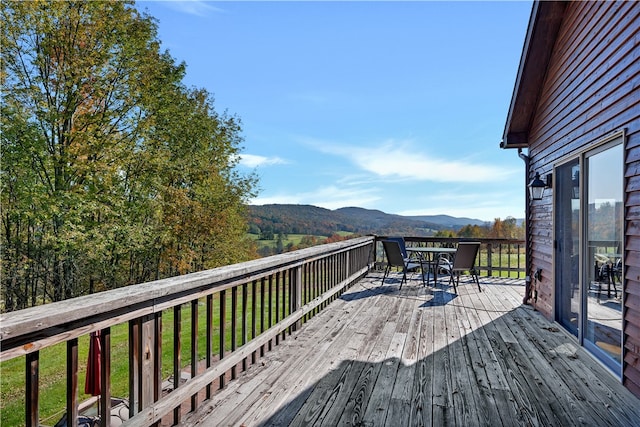 wooden deck with a mountain view