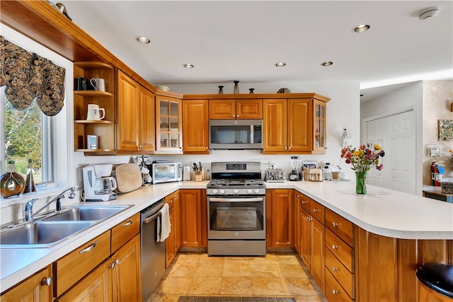 kitchen featuring appliances with stainless steel finishes, sink, and kitchen peninsula