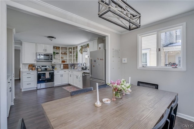 dining area with crown molding, sink, and dark wood-type flooring