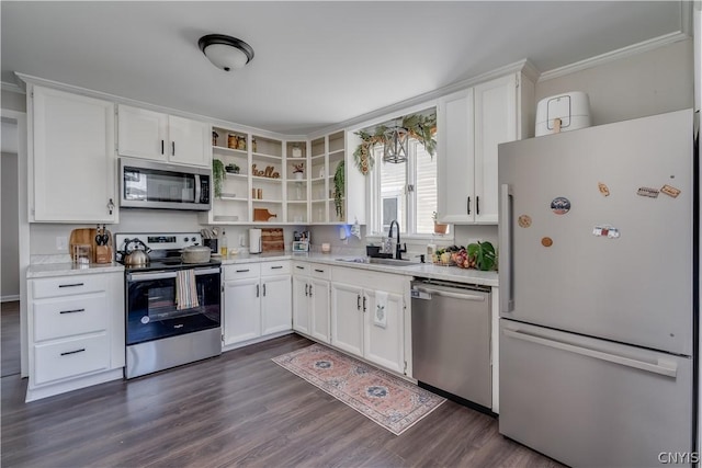 kitchen with white cabinetry, sink, ornamental molding, and appliances with stainless steel finishes