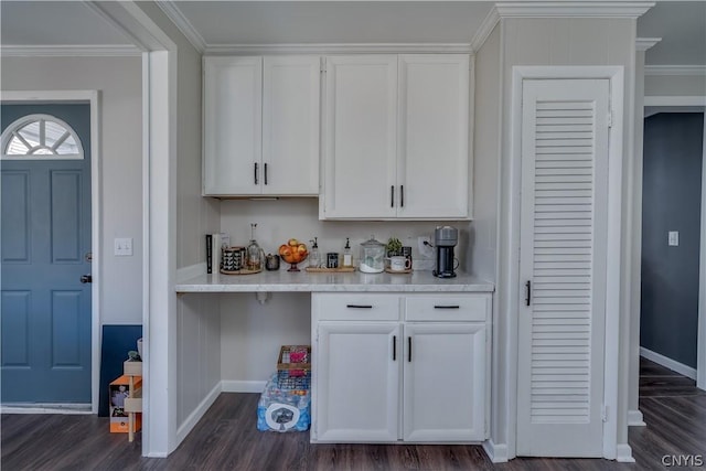 bar featuring white cabinetry, crown molding, and dark wood-type flooring