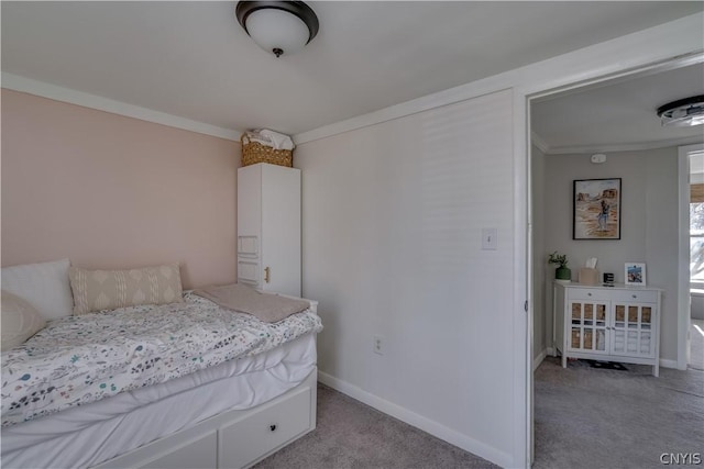 bedroom with crown molding and light carpet