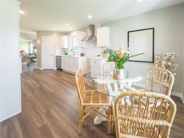 dining space with dark hardwood / wood-style flooring and sink