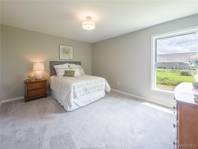 bedroom featuring multiple windows and light colored carpet