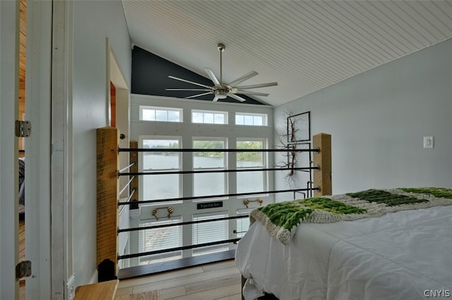 bedroom featuring light wood-type flooring, ceiling fan, and vaulted ceiling