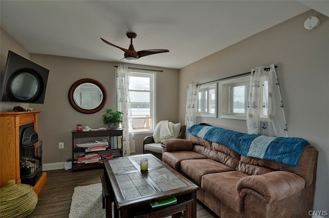 living room featuring dark hardwood / wood-style flooring and ceiling fan