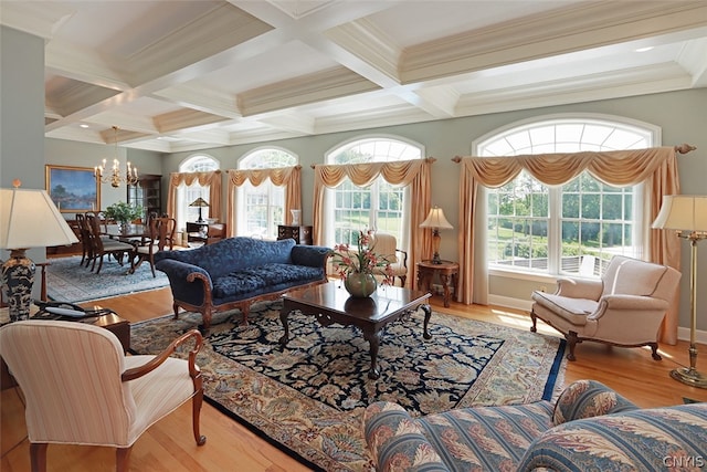 living room featuring a notable chandelier, crown molding, light wood-type flooring, beamed ceiling, and coffered ceiling