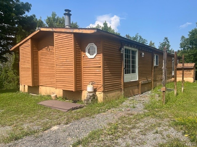 view of home's exterior with a lawn