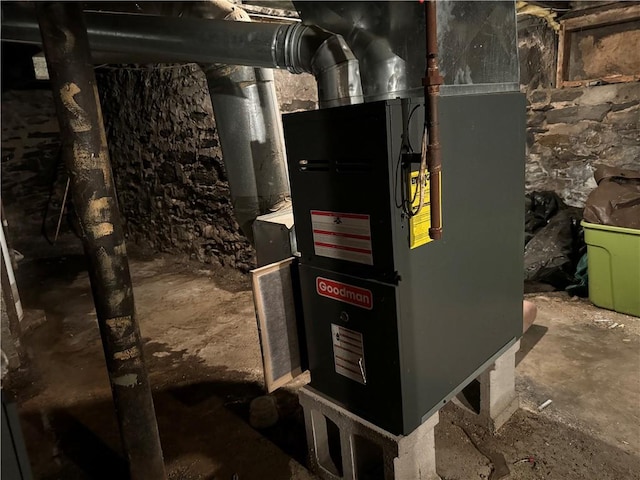 utility room featuring heating unit