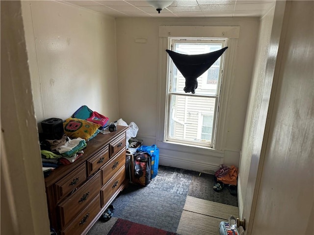 carpeted bedroom featuring a paneled ceiling