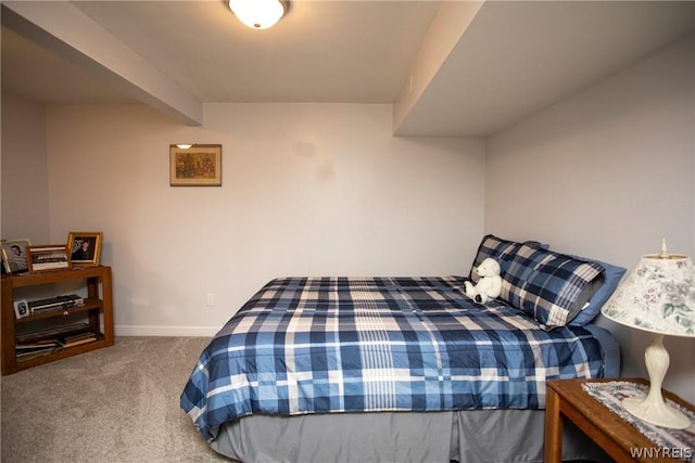 carpeted bedroom featuring baseboards and beam ceiling