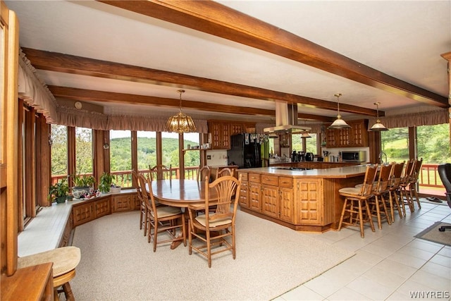 dining room with light tile patterned floors, a notable chandelier, and beamed ceiling