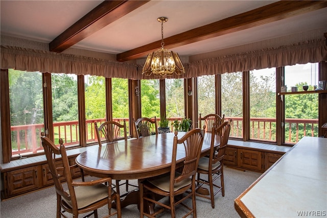 sunroom with beamed ceiling and an inviting chandelier