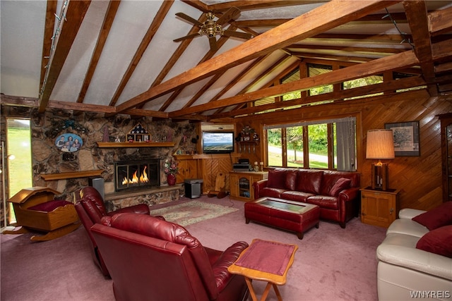 living room with beamed ceiling, high vaulted ceiling, a fireplace, and wooden walls