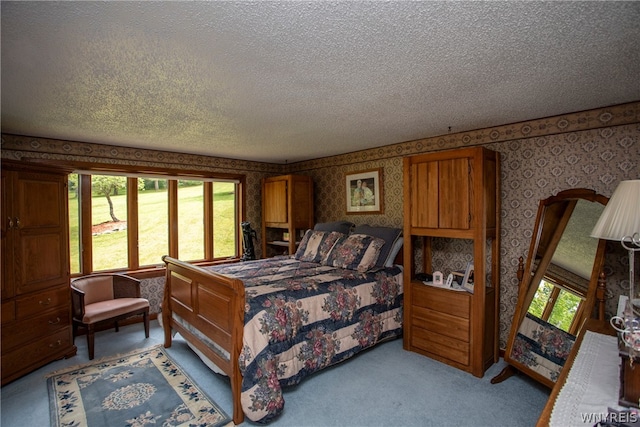 carpeted bedroom featuring a textured ceiling