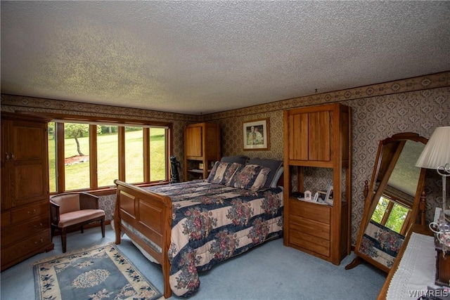 bedroom featuring wallpapered walls, multiple windows, a textured ceiling, and carpet flooring