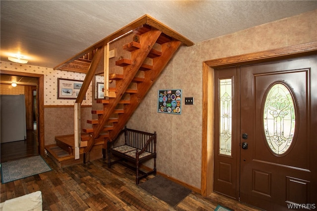 entrance foyer featuring dark hardwood / wood-style floors and a textured ceiling