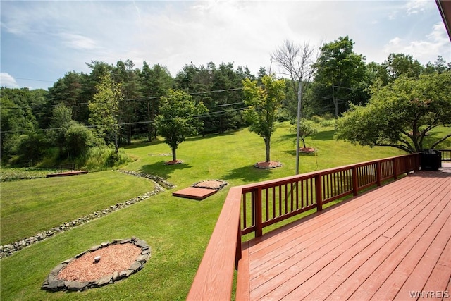 wooden terrace featuring a yard