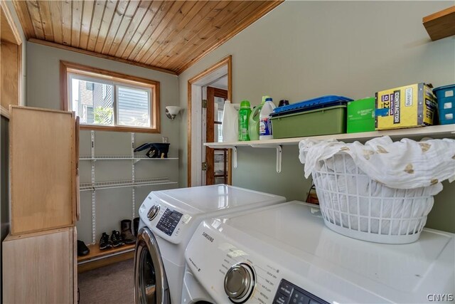 washroom featuring wood ceiling, carpet, and washing machine and clothes dryer